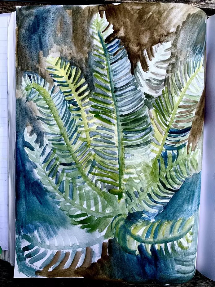 a watercolour painting of a fern in the forest. The fern is painted in shades of green, brown and blue, showing the colours bleeding into each other and the texture of the paint